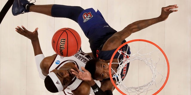 Liberty guard Lovell Cabbil Jr., right, shoots over Mississippi State forward Aric Holman during the second half of a first-round game in the NCAA men’s college basketball tournament Friday, March 22, 2019, in San Jose, Calif. (AP Photo/Ben Margot)