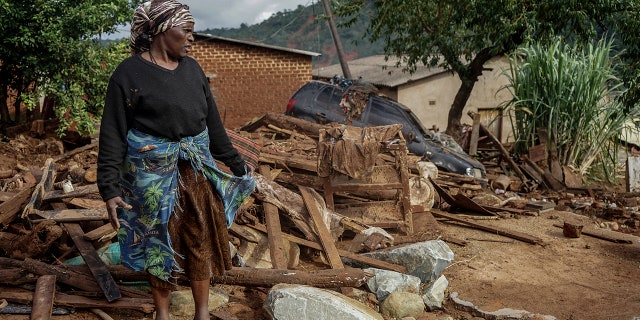 Jessica Mhonderi stands in front of what used to be her son's home in Chimanimani. Zimbabwe, Saturday, March 23, 2019. Mhonderi lost her daughter-in-law and three grandchildren to the Cyclone Idai induced rains last week that swept through Mozambique, Zimbabwe and Malawi.