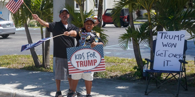 Supporters of President Donald Trump are seen from the media van in the motorcade accompanying the president in West Palm Beach, Fla., Saturday, March 23, 2019, en route to Mar-a-Lago in Palm Beach, Fla. (AP Photo/Carolyn Kaster)