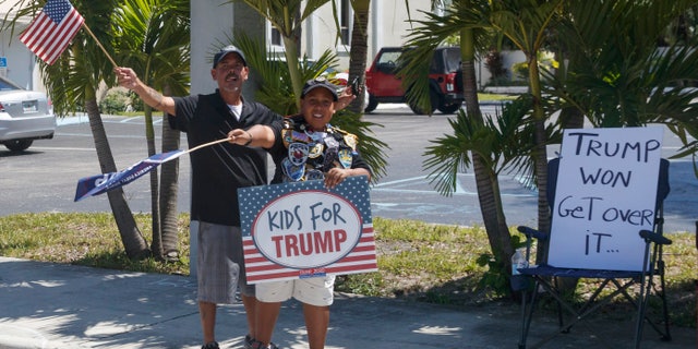 Supporters of President Donald Trump are seen from the media van in the motorcade accompanying the president in West Palm Beach, Fla., Saturday, March 23, 2019, en route to Mar-a-Lago in Palm Beach, Fla. (AP Photo/Carolyn Kaster)