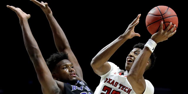 Texas Tech's Jarrett Culver (23) shoots past Buffalo's Nick Perkins (33) during the second half of a second-round men's college basketball game in the NCAA Tournament.