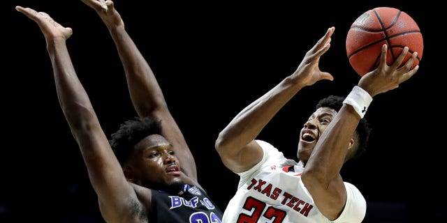 Texas Tech's Jarrett Culver (23) shoots past Buffalo's Nick Perkins (33) during the second half of a second-round men's college basketball game in the NCAA Tournament.