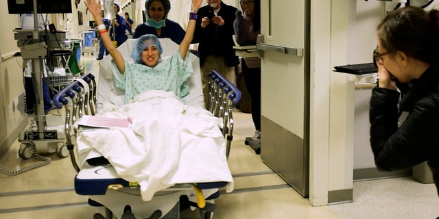 In this image made from video provided by Johns Hopkins Medicine, Nina Martinez of Atlanta is wheeled into a Baltimore operating room to become who is thought to be the world’s first kidney transplant living donor with HIV.