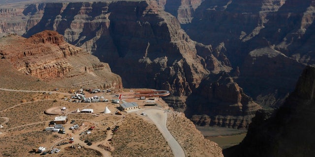 The Skywalk hangs over the Grand Canyon on the Hualapai Indian Reservation before its grand opening ceremony at Grand Canyon West, Ariz. Crews are searching for a tourist who slipped and fell over the edge of a Grand Canyon lookout on tribal land. (AP Photo/Ross D. Franklin, File)