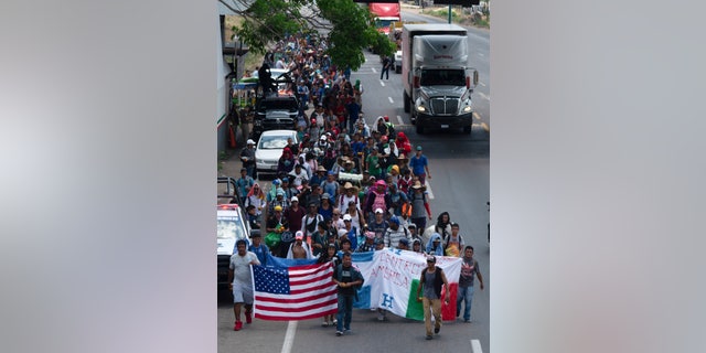 Central American migrants, part of the caravan hoping to reach the U.S. border, move on a road in Tapachula, Chiapas State, Mexico, Thursday, March 28, 2019. A caravan of about 2,500 Central Americans and Cubans is currently making its way through Mexico's southern state of Chiapas. [AP Photo/Isabel Mateos)