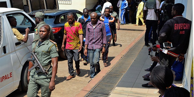 Men arrested in connection with Cameroon's anglophone crisis are seen at the military court in Yaounde, Cameroon, on December 14, 2018. - Nearly 300 people who were arrested in connection with Cameroon's anglophone crisis will be released on Friday, a day after being pardoned by President Paul Biya, the defense minister said.