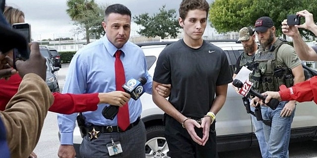 Austin Harrouff is transported by detectives to the Martin County jail from St. Mary's Hospital in Stuart, Fla.