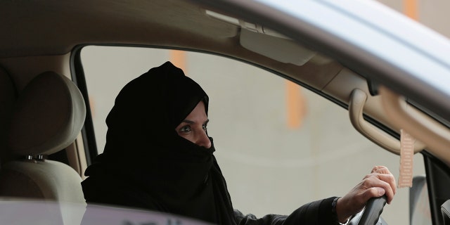 In this March 29, 2014 file photo, Aziza al-Yousef drives a car on a highway in Riyadh, Saudi Arabia, as part of a campaign to defy Saudi Arabia's then ban on women driving. (AP Photo/Hasan Jamali, File)