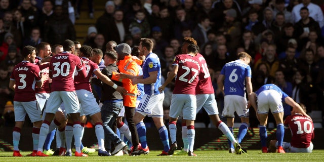 A fan was removed after attacking Aston Villa's Jack Grealish, right, on the pitch during the Sky Bet Championship soccer match at St Andrew's Trillion Trophy Stadium, Birmingham, England, on Sunday. (Nick Potts/PA via AP)