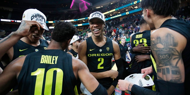 Oregon players, including Louis King (2) and Victor Bailey Jr., celebrate after defeating Washington 68-48 in an NCAA college basketball game in the final of the Pac-12 men's tournament Saturday, March 16, 2019, in Las Vegas.