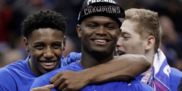 Duke's RJ Barrett, left, hugs Zion Williamson after Duke defeated Florida State in the NCAA college basketball championship game of the Atlantic Coast Conference tournament in Charlotte, N.C., Saturday, March 16, 2019.