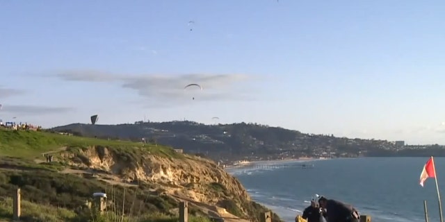 Stunned witnesses said the paragliders were "falling from the sky" after colliding.