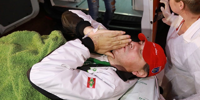 Brazilian radio journalist Rafael Henzel lies on a stretcher as he arrives at the hospital after he survived a plane crash with Brazilian soccer team Chapecoense aboard, in Chapeco, Brazil December 13, 2016. REUTERS/Diego Vara - RC1F46512B10