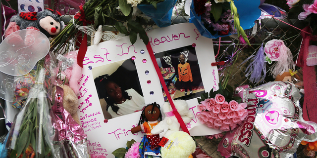 Dozens of tributes are seen at a large memorial to Trinity Love Jones, the 9-year-old girl whose body was found in a duffel bag along a suburban Los Angeles equestrian trail, in Hacienda Heights, Calif., Monday, March 11, 2019.
