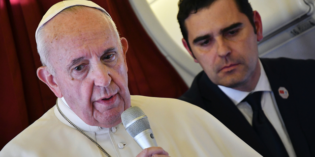 Pope Francis, flanked by interim director of Holy See Press Office, Alessandro Gisotti, speaks to reporters on board the flight back to Rome from a two-day trip to Morocco, Sunday, March 31, 2019. Francis sought Sunday to encourage greater fraternity between Christians and Muslims in Morocco, telling his flock that showing the country's Muslim majority they are part of the same human family will help stamp out extremism. (Alberto Pizzoli/Pool Photo via AP)