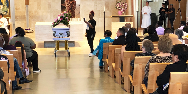 Mourners gather for the funeral service of Trinity Love Jones, the 9-year-old whose body was found this month stuffed in a duffel bag along an equestrian trail, at St. John Vianney Catholic Church in Hacienda Heights, Calif., Monday, March 25, 2019. The Hacienda Heights community where her body was found had embraced the child in death during the days she remained unidentified. A park worker found Trinity on March 5. A huge memorial sprang up at the site as community members heard about the case. She was identified the following weekend and prosecutors have since filed murder charges against her mother and the mother's boyfriend. (AP Photo/John Rogers)