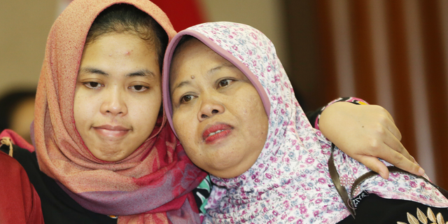 Indonesian Siti Aisyah, left, hugs her mother Benah, right, after a press conference at foreign minister office in Jakarta, Indonesia, Monday, March 11, 2019. The Indonesian woman held two years on suspicion of killing North Korean leader's half brother Kim Jong Nam was freed from custody Monday after prosecutors unexpectedly dropped the murder charge against her.