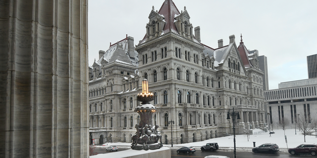 FILE - This Feb. 13, 2019 file photo shows the New York state Capitol building as seen from the steps of the New York state Education Department Building, in Albany, N.Y. Though leaders such as Democratic Gov. Andrew Cuomo insist New York has a tough law on sexual harassment, with more changes proposed in the current legislative session, allegations that roiled a 20-employee office in Glens Falls underscore a familiar criticism: Aggressive policies at state agencies aren't of much use if managers don't take action. (AP Photo/Hans Pennink, File)