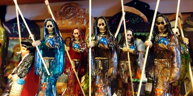 FILE - In this Feb. 13, 2013 file photo, statues of La Santa Muerte, an underworld saint most recently associated with the violent drug trade in Mexico, are shown at the Masks y Mas art store in Albuquerque, N.M. Santa Fe Archbishop John Wester recently told The Associated Press he believes some Catholics may be fooled into venerating Santa Muerte even though the focus on death runs counter to the church's teachings and she's not an official Catholic saint. (AP Photo/Russell Contreras, File)