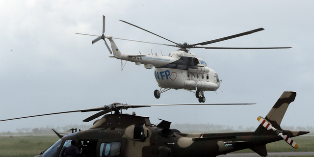 A World Food Program helicopter takes off, in Beira, Mozambique, March 22, 2020. (AP Photo/Themba Hadebe)