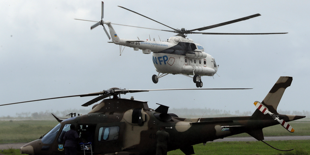 A World Food Program helicopter takes off, in Beira, Mozambique, March 22, 2020. (AP Photo/Themba Hadebe)