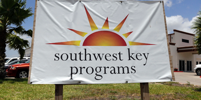 FILE - This June 20, 2014, file photo shows a Southwest Key program sign in Brownsville, Texas. Authorities in Arizona say workers who were seen on video dragging and shoving immigrant children being held at a privately run shelter won't face charges. The Maricopa County Attorney's Office said Friday, March 29, 2019 that there's no reasonable likelihood of proving the workers at a Southwest Key facility committed a crime. (AP Photo/Eric Gay, File)