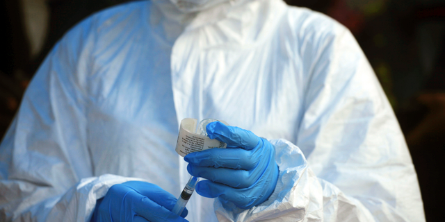 Aug. 8, 2018: A health care worker from the World Health Organization prepares to give an Ebola vaccination in Mangina, Democratic Republic of Congo.