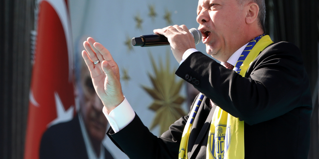 Turkey's President Recep Tayyip Erdogan sings a political song before his address to the supporters of his ruling Justice and Development Party, AKP, during a rally in Ankara, Turkey