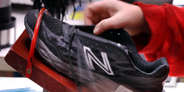 FILE- In this Dec. 17, 2018, file photo, a pair of athletic shoes designed for the military are laced up at a New Balance factory in Norridgewock, Maine. On Friday, March 1, 2019, the Institute for Supply Management, a trade group of purchasing managers, issues its index of manufacturing activity for February. (AP Photo/Robert F. Bukaty, File)