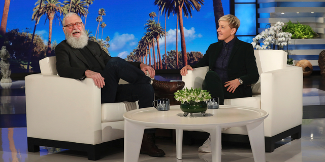 In this March 7, 2019 photo released by Warner Bros., David Letterman appears with host Ellen DeGeneres during a taping of "The Ellen DeGeneres Show" in Los Angeles.