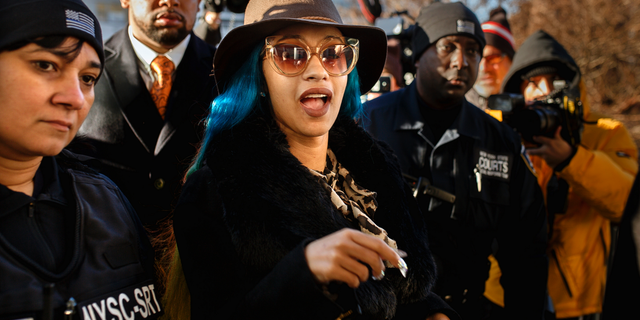 Rapper Cardi B, center, arrives at Queens County Criminal Court in New York on charges related to a brawl at a New York strip club, Dec. 7, 2018. (Associated Press)