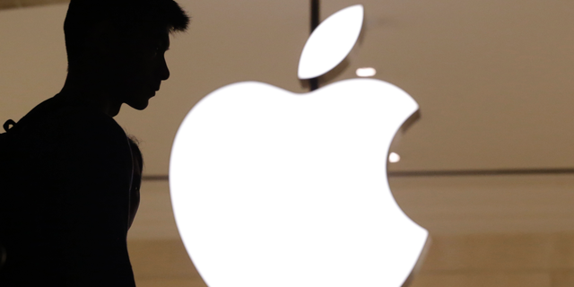 A customer enters an Apple Store.