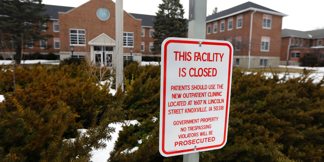 A facility closed sign hangs in front of the main building on the Veterans Affairs campus, Tuesday, March 12, 2019, in Knoxville, Iowa. Since the Veterans Affairs moved out of the sprawling campus on the edge of Knoxville a decade ago, local leaders have become increasingly anxious about the ghost town on the edge of their living community. (AP Photo/Charlie Neibergall)