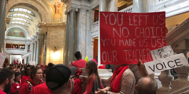 Teachers and public education supporters fill the Kentucky Capitol on Wednesday, March 13, 2019, in Frankfort, Kentucky. Jefferson County Public Schools, the state's largest school district, closed Wednesday for the fifth time in the past two weeks after teachers called in sick so they could come to Frankfort to keep an eye on lawmakers. But one of the proposals teachers were most concerned about, which would have indirectly supported private schools with tax credits, was not included in an agreement on a tax bill lawmakers finished on Wednesday. (AP Photo/Adam Beam)