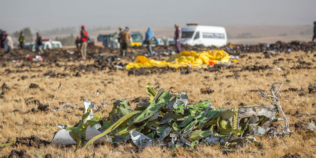 Parts of the plane wreckage with rescue workers at the crash site at Bishoftu, or Debre Zeit, outside Addis Ababa, Ethiopia, Monday, March 11, 2019, where Ethiopia Airlines Flight 302 crashed Sunday.