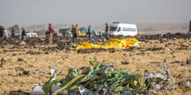 Parts of the plane wreckage with rescue workers at the crash site at Bishoftu, or Debre Zeit, outside Addis Ababa, Ethiopia, Monday, March 11, 2019, where Ethiopia Airlines Flight 302 crashed Sunday.