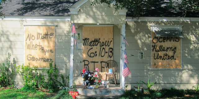 A makeshift memorial was set up in front of Tuttle and Nicholas' home following the raid. (AP Photo/Juan Lozano)