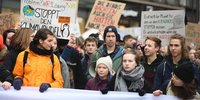 Swedish climate activist Greta Thunberg, front with white cap, attends a protest rally in Hamburg, Germany, on March 1, 2019. (Daniel Reinhardt/dpa via AP, file)