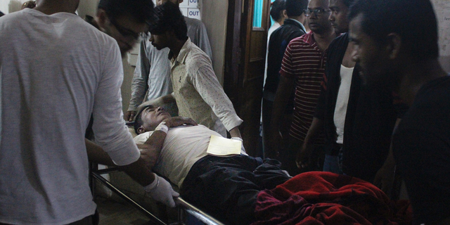 An Injured of rain storm from Bara district is being brought to a government hospital, in Birgunj, 136 kilometers (85 miles) from Kathmandu, Nepal, March 31, 2019. Officials say many people were killed and hundreds were injured by a rainstorm that swept southern Nepal on Sunday. (AP Photo/Jiyalal Sah)