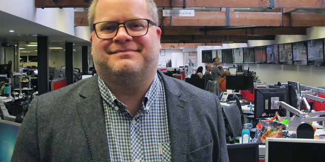 Associated Press journalist Matt Chandler poses for a photo in the newsroom of AP's London bureau, Friday, March 1, 2019. The international news cooperative announced Friday that Chandler, a senior news leader who has produced award-winning coverage of drug trafficking and cartel violence in Mexico and investigations into Central American gangs, has been named News Director for Latin America and the Caribbean. (AP Photo)