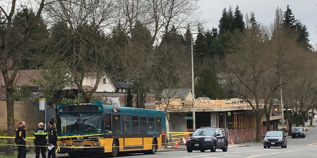 REMOVES SPECIFIC NUMBER OF PEOPLE WHO WERE SHOT, AS STORY DETAILS CONTINUE TO DEVELOP - Investigators work at the scene of a shooting in Seattle on Wednesday, March 27, 2019. (AP Photo/Gene Johnson)
