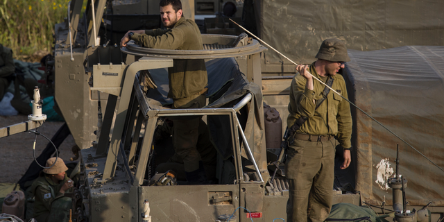 Israeli soldiers sit on top of mobile artillery near the border with Gaza, in southern Israel, Wednesday, March 27, 2019. (AP Photo/Tsafrir Abayov)