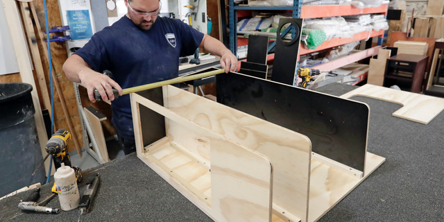 FILE- In this July 11, 2018, file photo a worker assembles interior cabinets for a boat at Regal Marine Industries in Orlando, Fla. Last week the Commerce Department said factory orders rose 0.1 percent in January, a tiny increase that matched December’s reading but fell short of many economists’ forecasts. (AP Photo/John Raoux, File)