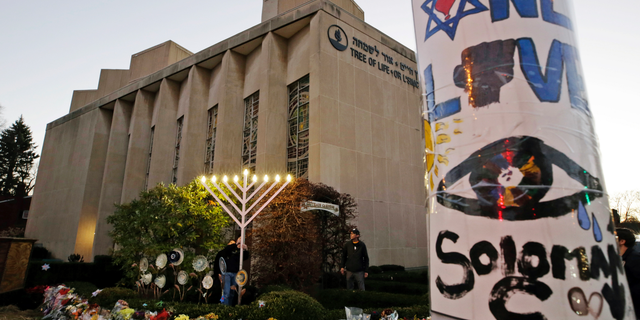 A menorah is tested outside the Tree of Life Synagogue in preparation for a celebration service at sundown on the first night of Hanukkah, in the Squirrel Hill neighborhood of Pittsburgh, on Dec. 2, 2018. (AP Photo/Gene J. Puskar, File)