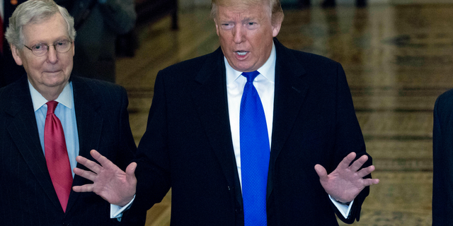 President Donald Trump accompanied by Senate Majority Leader Mitch McConnell of Ky., left, arrives for a Senate Republican policy lunch on Capitol Hill in Washington, Tuesday, March 26, 2019. (AP Photo/Jose Luis Magana)
