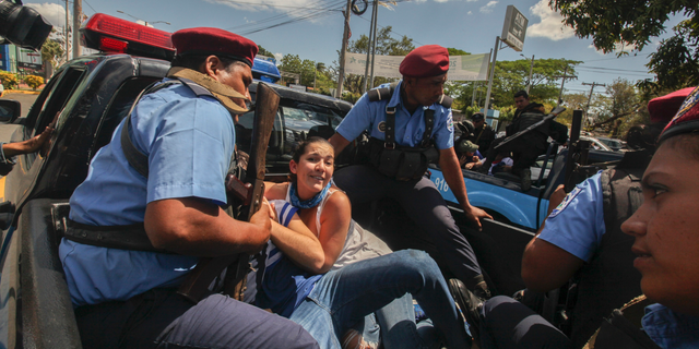 Police detain protesters in Managua, Nicaragua, on Saturday. (AP Photo/Alfredo Zuniga)