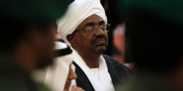 FILE - In this Oct. 25, 2011 file photo, Sudanese President Omar al-Bashir attends the funeral of Saudi Crown Prince Sultan bin Abdul-Aziz Al Saud, in Riyadh, Saudi Arabia. In a report issued Tuesday, March 27, 2019, New York-based Human Rights Watch described al-Bashir as a "fugitive from international justice" because he is wanted by the International Criminal Court for charges of genocide linked to the Darfur conflict. The rights group urged Tunisia to either "bar or arrest" Sudanese President Omar al-Bashir if he tries to attend an Arab League summit this weekend. (AP Photo/Hassan Ammar, File)