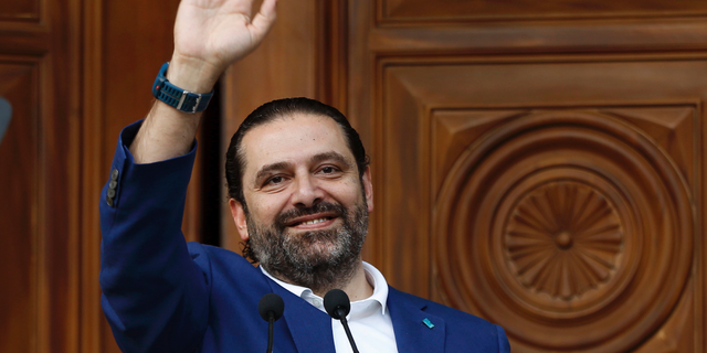 FILE -- In this May, 11, 2018 file photo, Lebanese Prime Minister Saad Hariri, waves to his supporters at his house in downtown Beirut, Lebanon. According to his office, Hariri, 48, was admitted to a Paris hospital Monday, March 25, 2019, where he underwent an hour-long angioplasty procedure, used to treat blocked arteries. Hariri is expected to be discharged Monday. (AP Photo/Bilal Hussein, File)