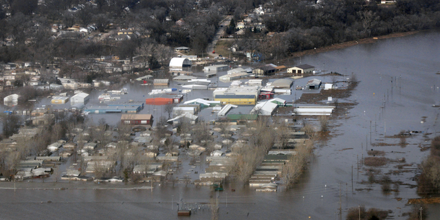 This March 17, 2019 photo released by the U.S. Air Force shows an aerial view of Areas surrounding Offutt Air Force Base affected by flood waters in Neb. Surging unexpectedly strong and up to 7 feet high, the Missouri River floodwaters that poured on to much the Nebraska air base that houses the U.S. Strategic Command overwhelmed the frantic sandbagging by troops and their scramble to save sensitive equipment, munitions and aircraft. (Tech. Sgt. Rachelle Blake/The U.S. Air Force via AP)