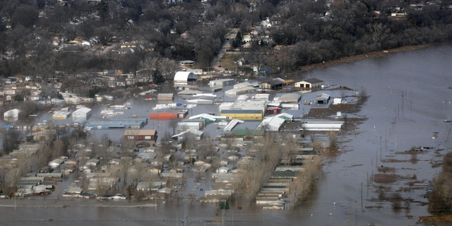 This March 17, 2019 photo released by the U.S. Air Force shows an aerial view of Areas surrounding Offutt Air Force Base affected by flood waters in Neb. Surging unexpectedly strong and up to 7 feet high, the Missouri River floodwaters that poured on to much the Nebraska air base that houses the U.S. Strategic Command overwhelmed the frantic sandbagging by troops and their scramble to save sensitive equipment, munitions and aircraft. (Tech. Sgt. Rachelle Blake/The U.S. Air Force via AP)